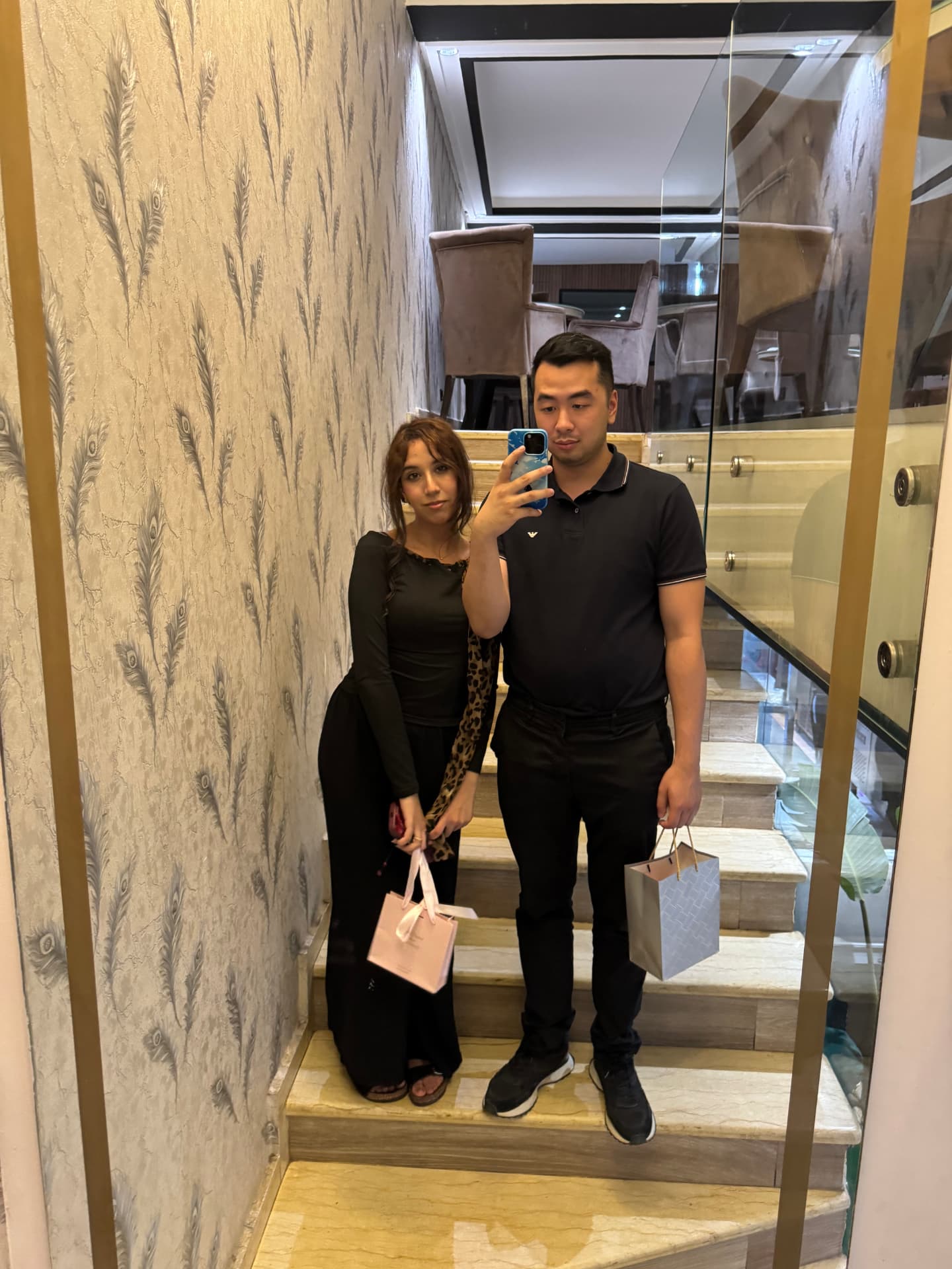 A couple taking a selfie as they leave a restaurant