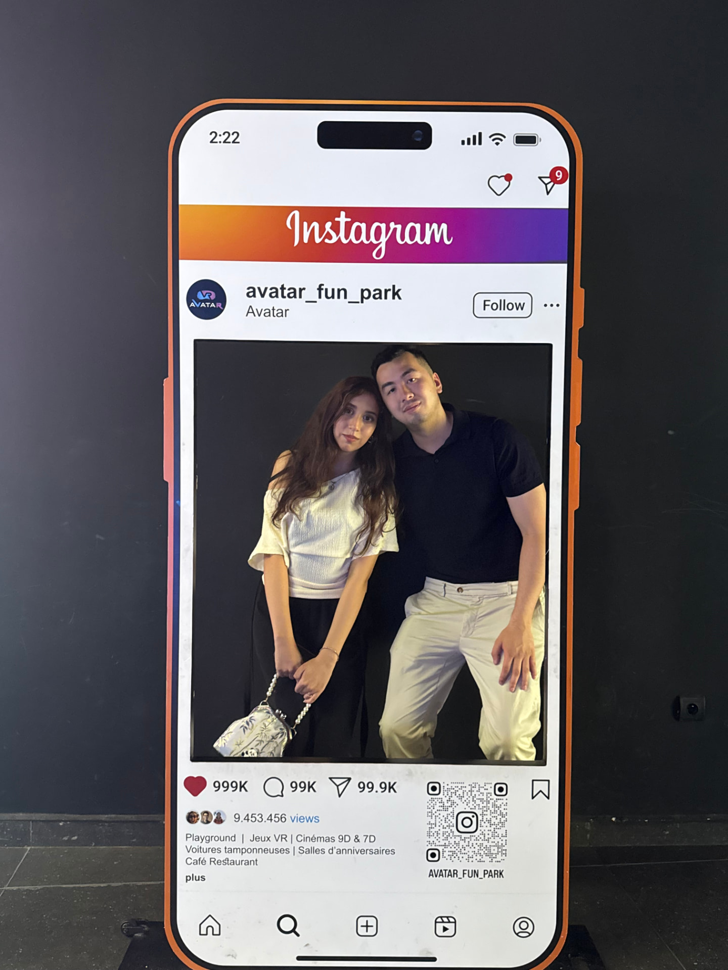 A couple posing in a giant phone frame prop